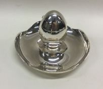 A heavy silver egg cup on stand. Sheffield 1927. B