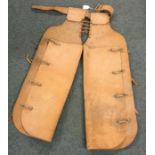 A pair of leather western chaps, possibly for a ch