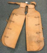 A pair of leather western chaps, possibly for a ch