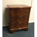 A mahogany serpentine chest of three drawers. Est.
