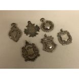 A group of six silver watch chain medallions. Est.