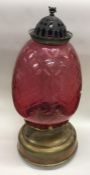 A cranberry glass and brass mounted oil lamp. Est.