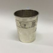 A silver christening mug with chased decoration. A