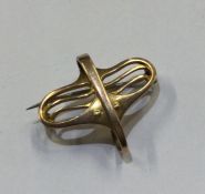 MERLE BENNETT: A stylish gold brooch with pierced