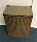 An old Lloyd Loom linen basket. Est. £30 - £50.