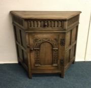 An oak hall cupboard. Est. £60 - £80.