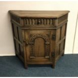 An oak hall cupboard. Est. £60 - £80.