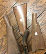 Three gun stocks to include an Enfield Army Rifle