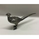 A large silver figure of a bird bearing import mar