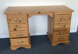 A pine eight drawer desk. Est. £20 - £30.
