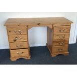 A pine eight drawer desk. Est. £20 - £30.