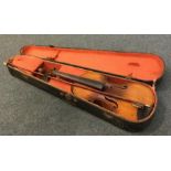 An old cased violin. Est. £30 - £40.