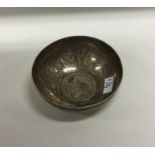 A silver tumbler with early coin to centre. Approx