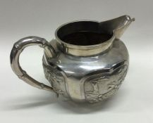A Chinese silver cream jug with panelled decoratio