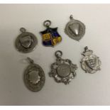 A group of six silver watch chain medallions. Est.