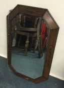 An oak wall mirror. Est. £20 - £30.