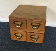 A four drawer stationery chest. Est. £20 - £30.
