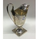 A large Adams' style silver cream jug on square ba