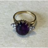 An Amethyst and diamond cluster ring. Approx. 9 gra