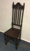 An Antique oak hall chair. Est. £15 - £20.