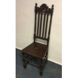 An Antique oak hall chair. Est. £15 - £20.