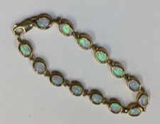 An attractive opal line bracelet in gold frame. Ap