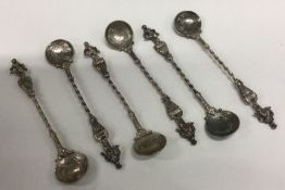 A set of six figural silver spoons with coins to b
