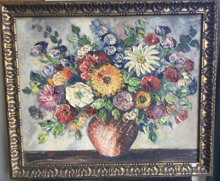 A gilt framed oil on board depicting a still life with flowers. Indistinctly signed to bottom right