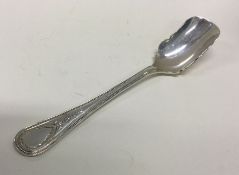 A heavy silver stilton scoop with ball decoration.