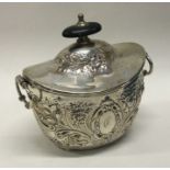 A chased silver boat shaped tea caddy. Approx. 137