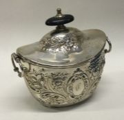 A chased silver boat shaped tea caddy. Approx. 137