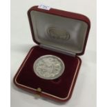 A Judaica silver medallion in case, inscribed, 'At