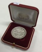 A Judaica silver medallion in case, inscribed, 'At