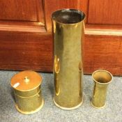 Three pieces of brass trench art. Est. £30 - £40.