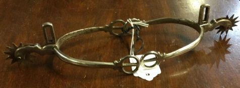 A large pair of spiked spurs. Est. £20 - £30.