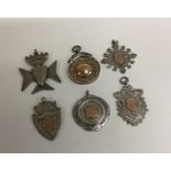 A group of six silver watch chain medallions. Est.