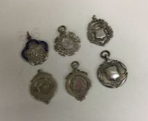 A group of six silver watch chain medallions. Est.