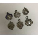 A group of six silver watch chain medallions. Est.