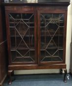 A mahogany glazed two door bookcase. Est. £100 - £