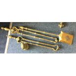 A brass companion set together with a weight. Est.