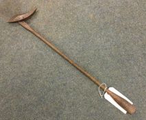 An iron toggle harpoon. Est. £50 - £80.