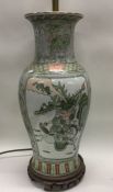 A large Chinese lamp decorated with warriors. Est.