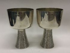A heavy pair of contemporary silver beakers with t
