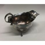 A small Edwardian silver sauce boat with card cut