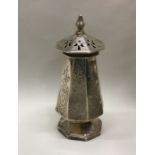 An early Victorian silver pepper with engraved dec