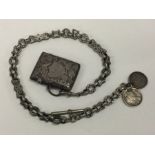 An engraved silver vesta case on albert chain. App