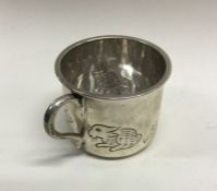 A silver christening mug with chased nursery anima