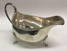 An 18th Century silver sauce boat with beaded rim.