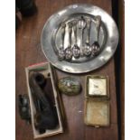 A box containing pipes, binoculars, spoons etc. Es