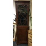A tall mahogany glazed corner cabinet. Est. £50 -